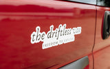 Red RV rental van featuring "the driftless van" sticker: "FREEDOM TO EXPLORE". Ready for your next adventure.
