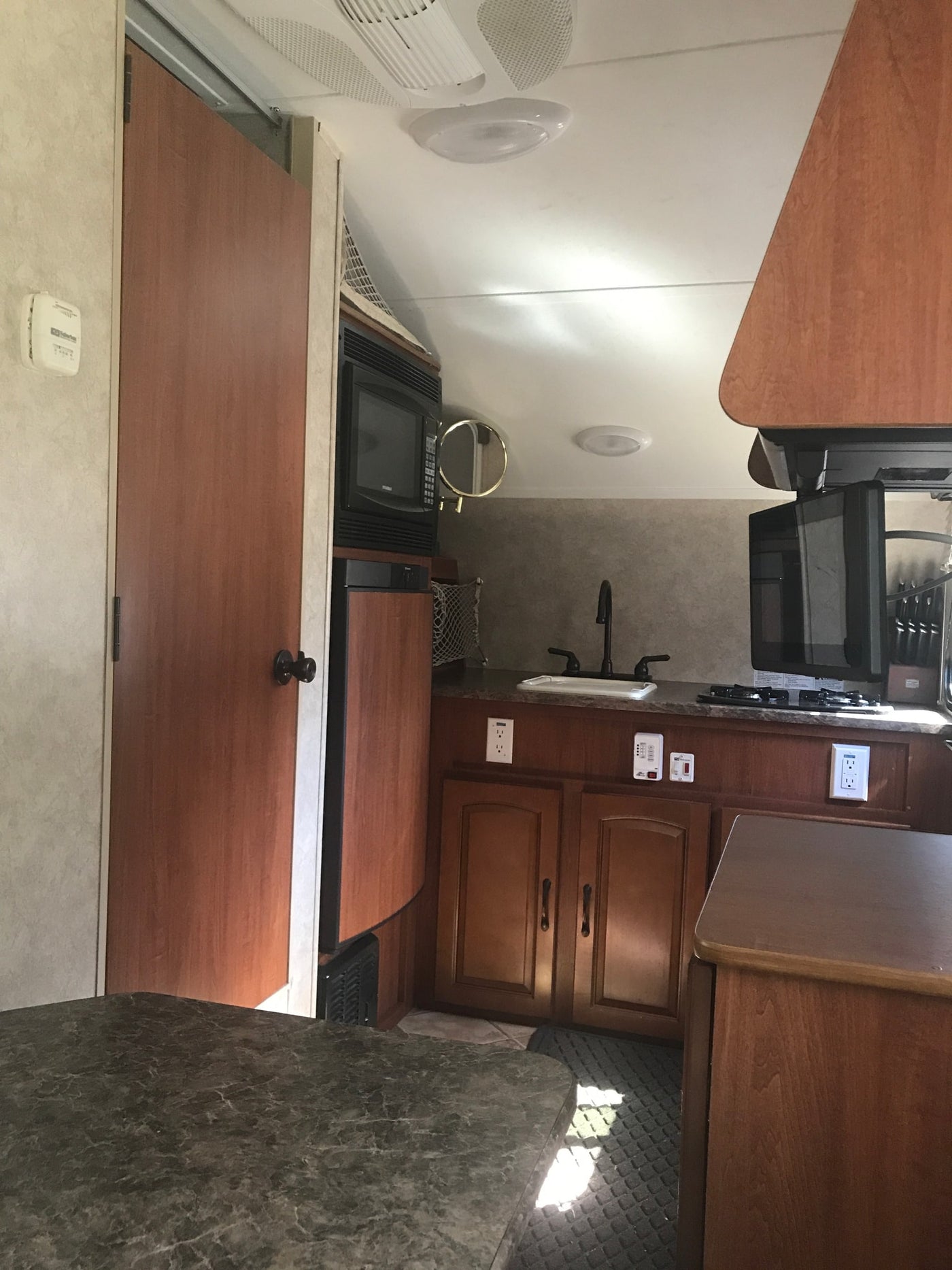  featuring colorful ring decals on its side.|Cozy dinette inside an RV rental — photo 6