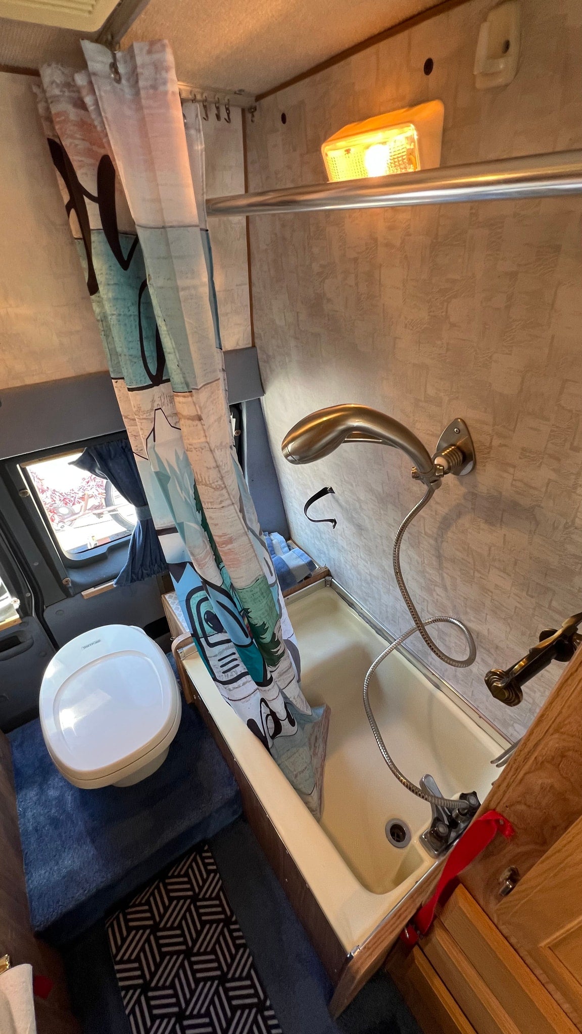  and bathroom.|This rv rental interior shows a main bed — photo 8