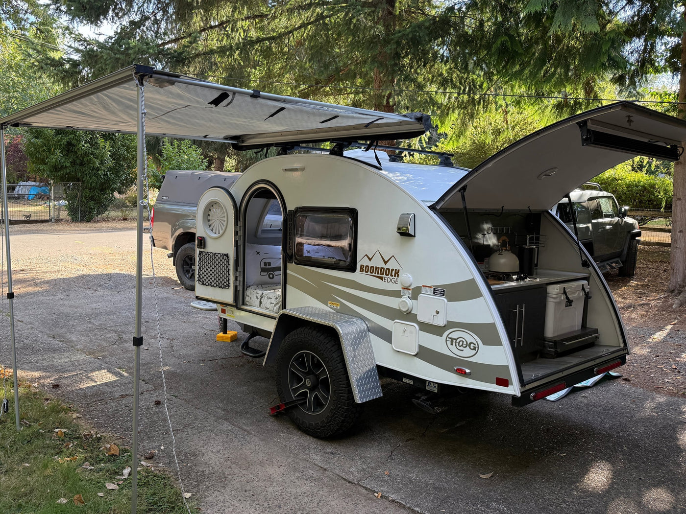 This teardrop RV rental is set up with an extended awning — photo 1