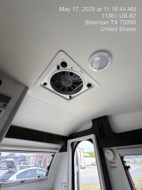 RV rental's clean interior: features a large roof vent with fan, LED light, and outside view via windows.