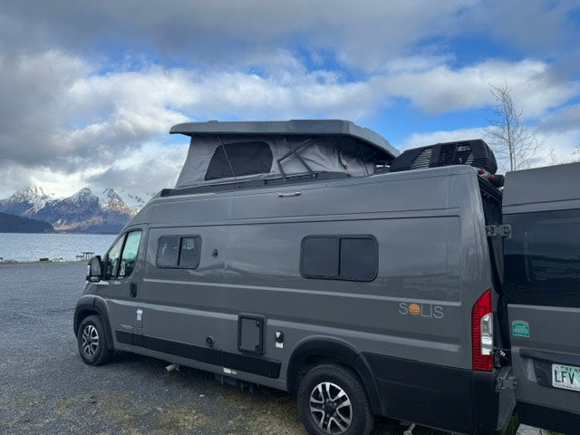 Enjoy an RV rental: Grey Winnebago Solis camper van with pop-top roof