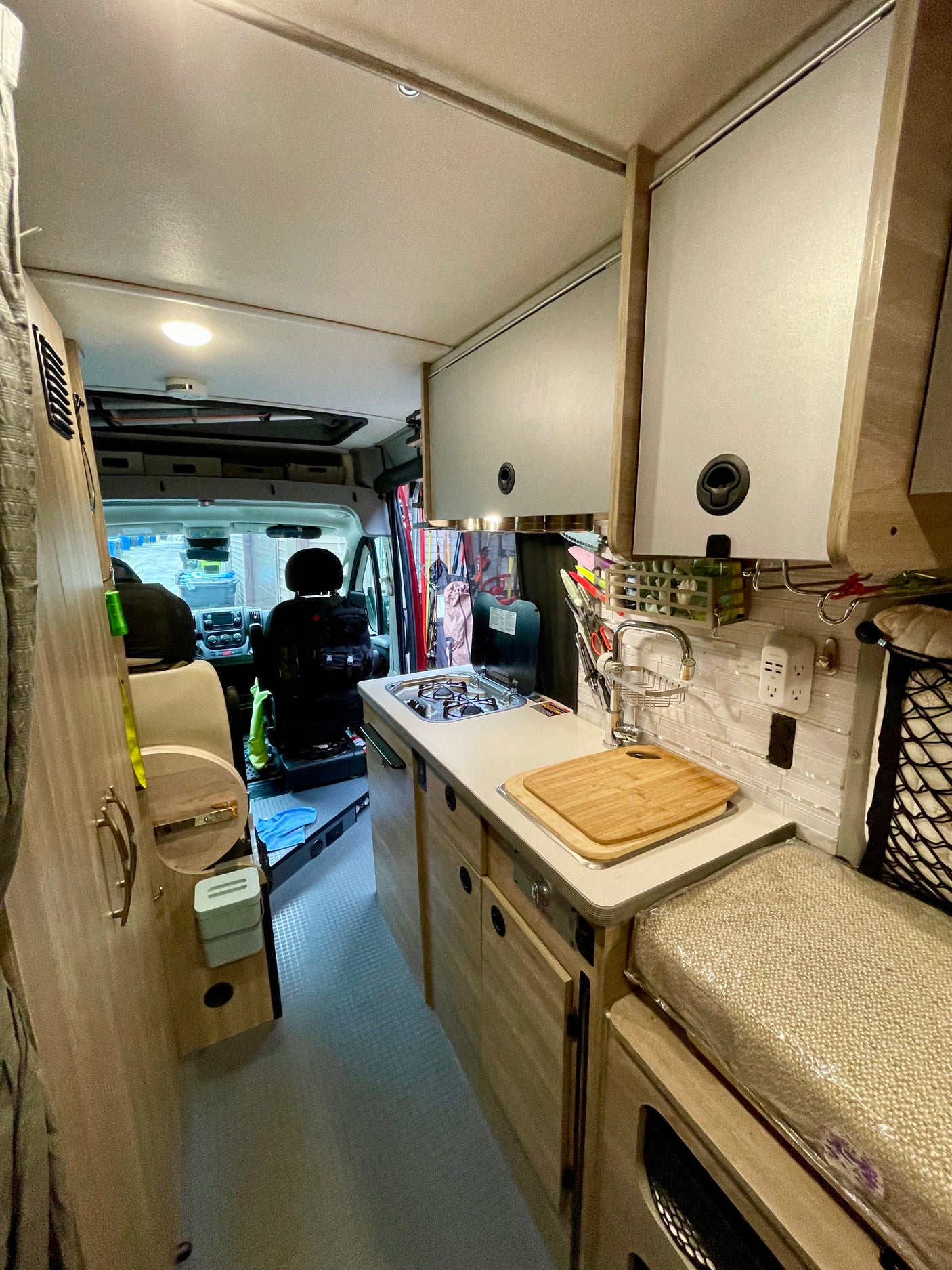 Explore this compact and functional kitchenette inside an RV rental, featuring a stove, sink, and ample storage for on-the-go living.