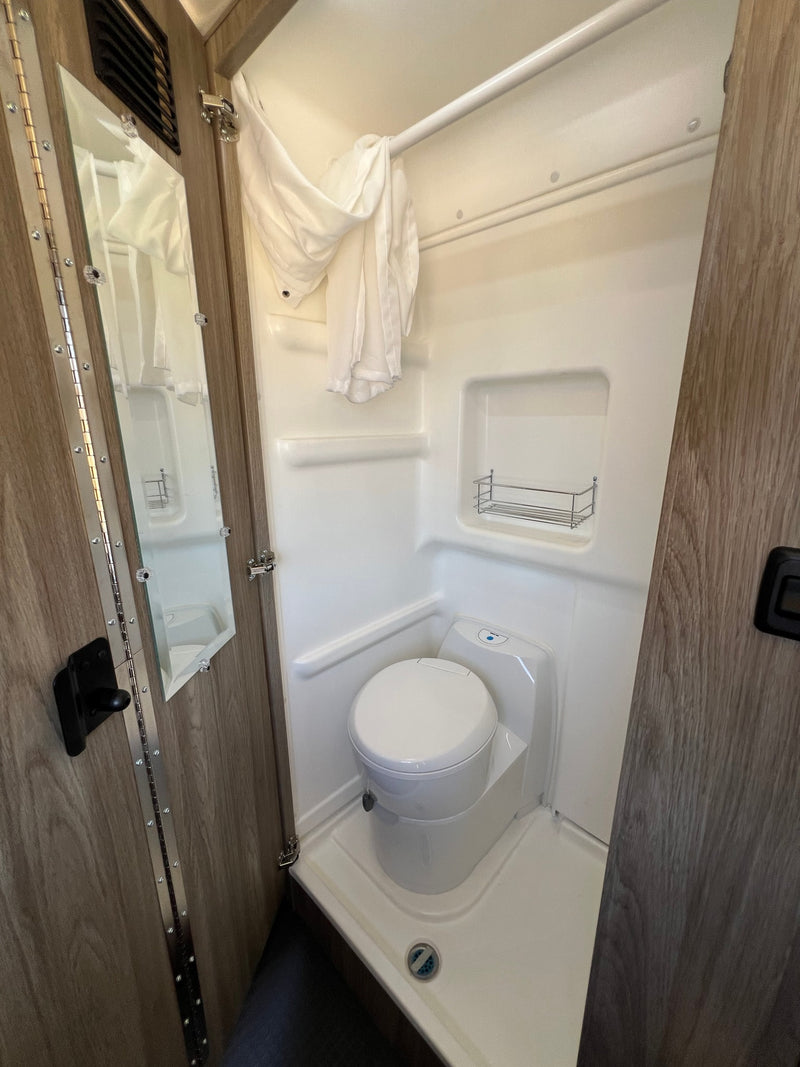  parked outdoors by a tree & playset. Ready for adventure.|RV rental: Grey camper van with open door — photo 3