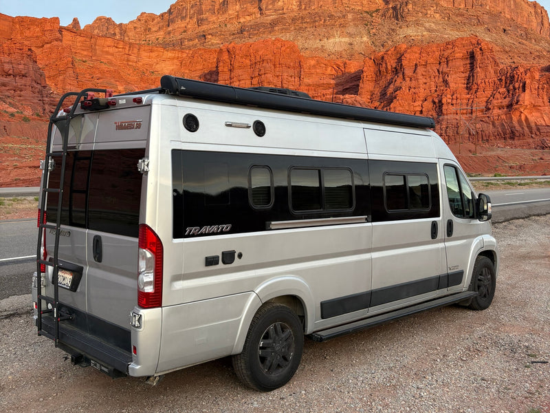 This silver Winnebago Travato rv rental offers stunning views of red rock cliffs, perfect for a scenic road trip vacation. — photo 2
