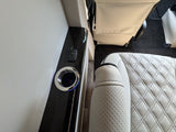 Luxury RV rental interior with comfortable seating, illuminated cup holder, and convenient USB charging port for travel comfort.