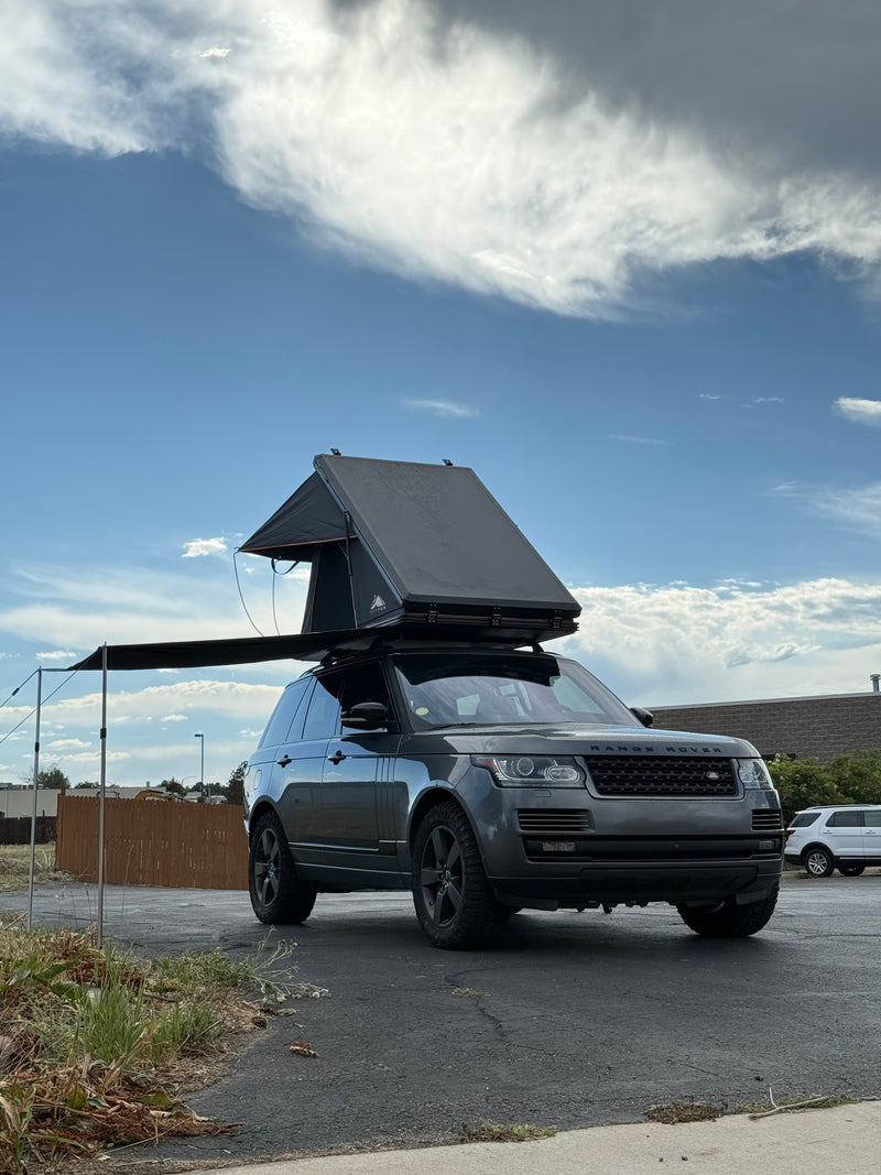 Adventure-ready Range Rover, an RV rental alternative with rooftop tent & awning for outdoor exploration. — photo 7