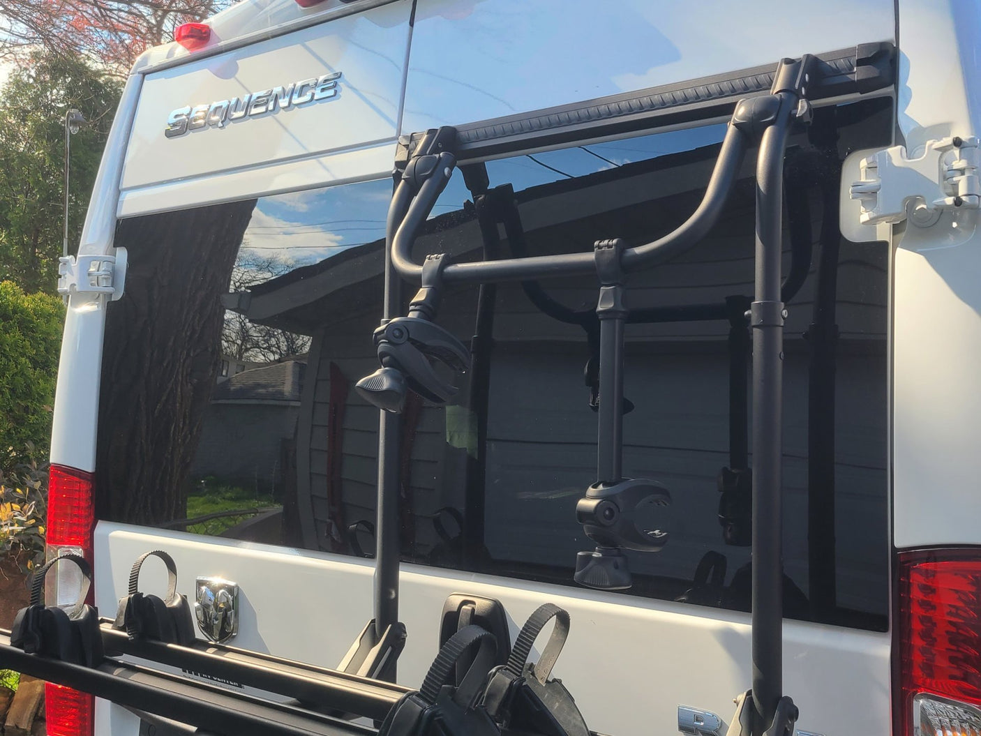 White Sequence RV rear, featuring a robust bike rack attached to doors. Perfect for an rv rental trip!