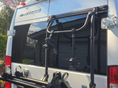 White Sequence RV rear, featuring a robust bike rack attached to doors. Perfect for an rv rental trip!