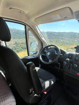 RV rental: Driver's view from inside the van, showcasing the dashboard and a beautiful mountainous landscape outside.