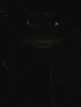 Extremely dark RV rental interior at night, with only faint outlines of the cabin visible.