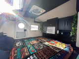 Step inside this bright RV rental! Features a comfy bed, AC, overhead fan, and windows, all in a compact camper interior.