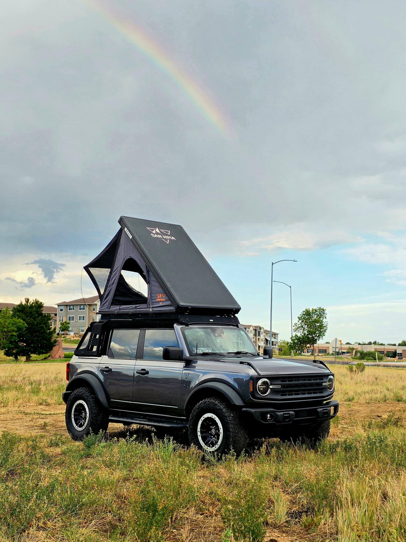  parked in a grassy field under a rainbow. Your adventure starts here — photo 4