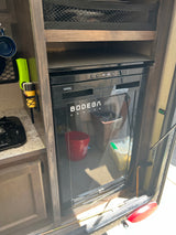 Compact RV rental kitchenette featuring a built-in Bodega cooler, ideal for efficient travel and convenient storage.