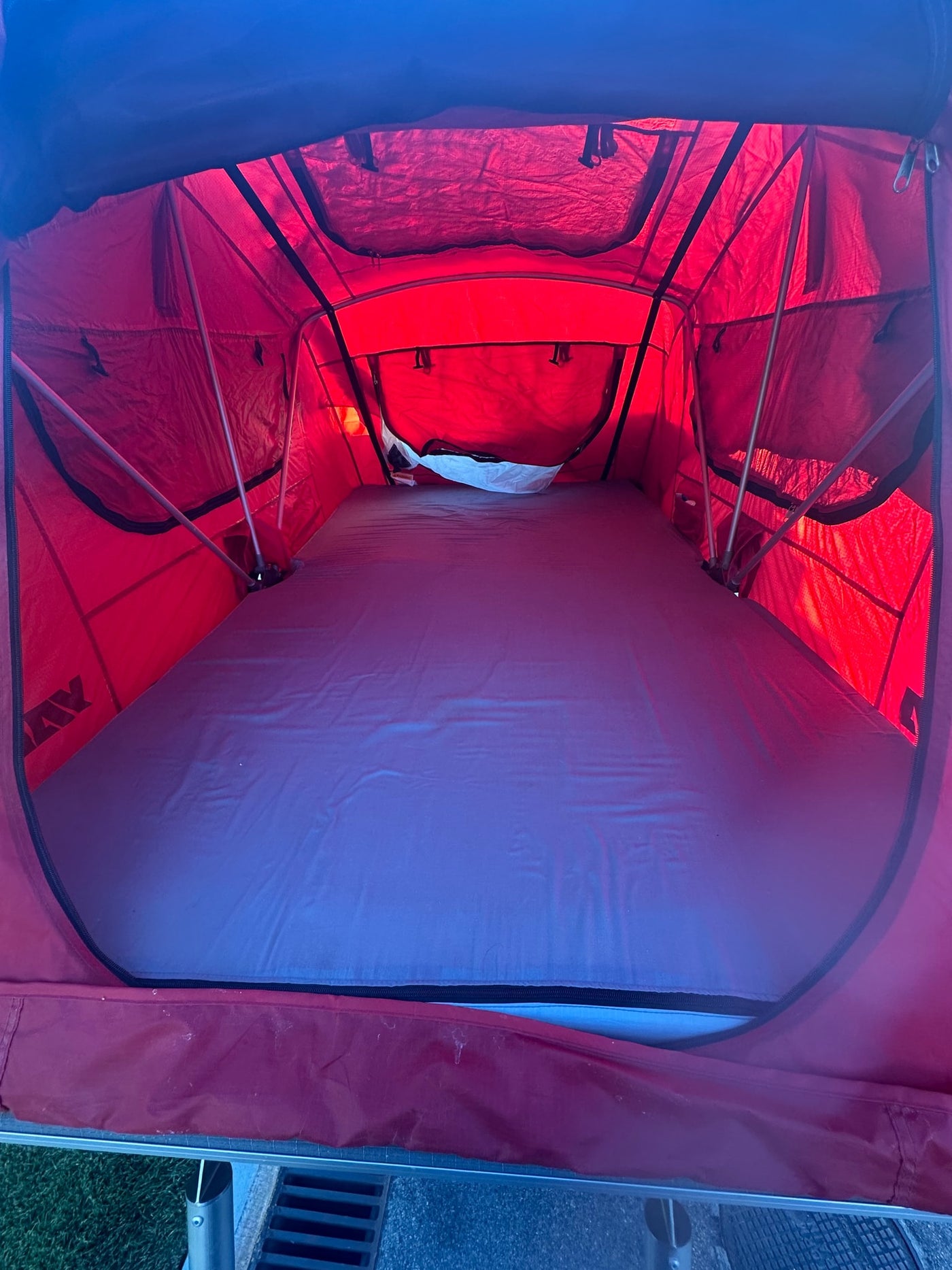  perfect for rugged camping adventures. Features an AC unit & spare tire.|Inside a red rooftop tent — photo 3