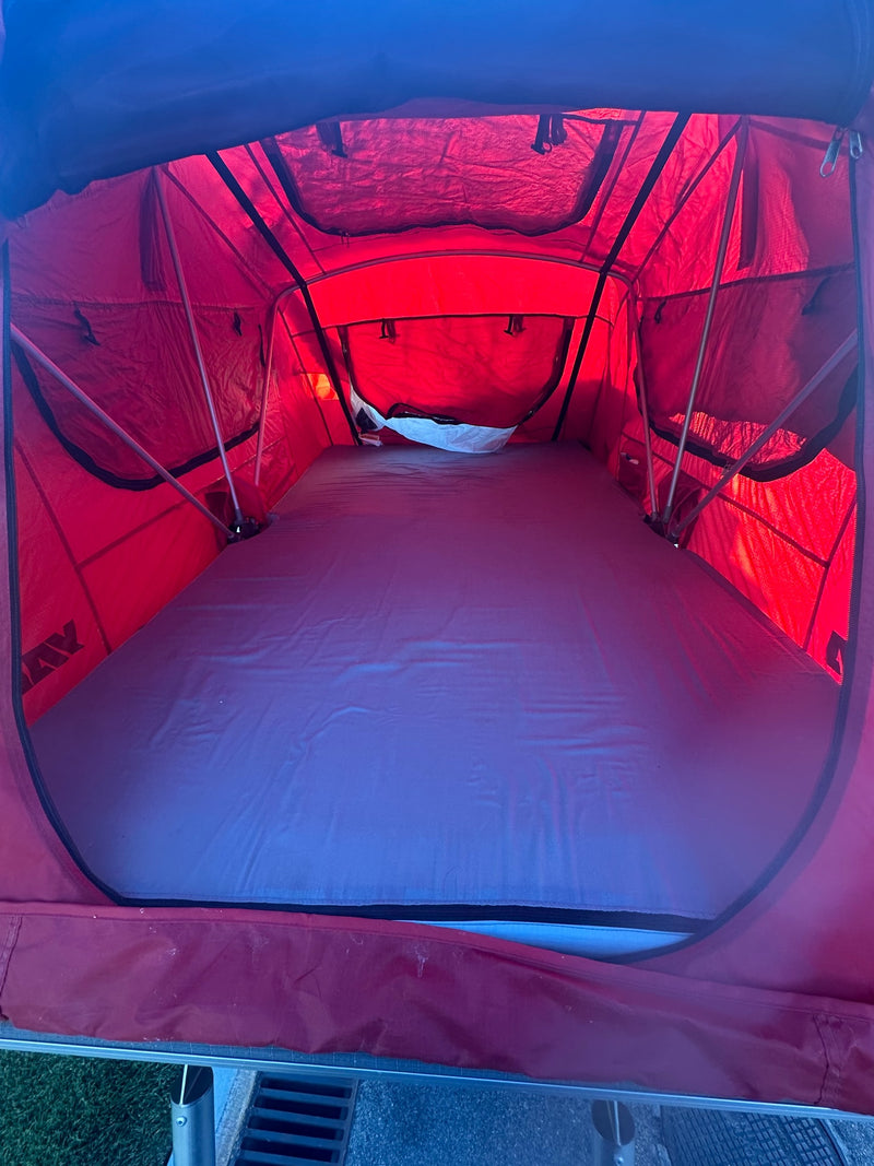  perfect for rugged camping adventures. Features an AC unit & spare tire.|Inside a red rooftop tent — photo 3