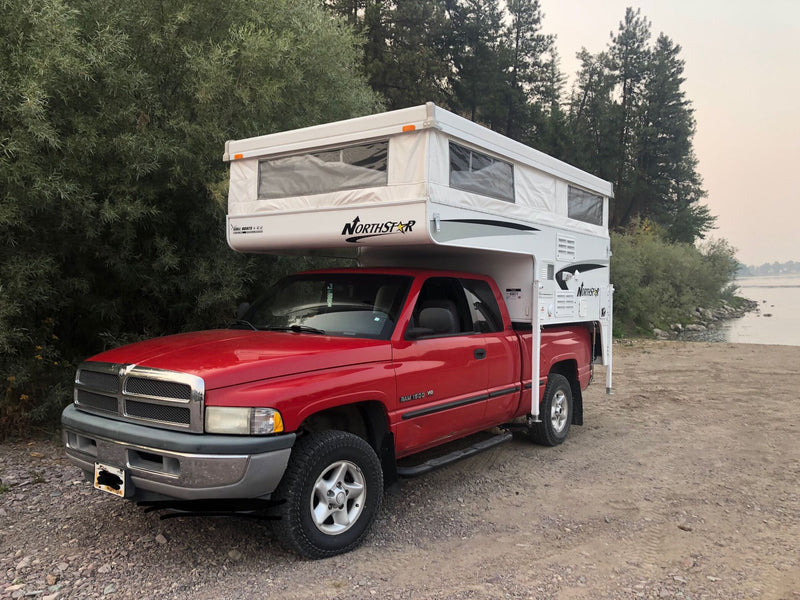 Red Dodge Ram with a Northstar pop-up truck camper. Ideal for an RV rental camping adventure by the water.|Red Dodge Ram 1500 V8 truck with Northstar camper — photo 1