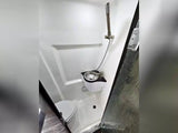 Inside an **rv rental**, a compact white wet bath featuring a toilet, a small sink, and a shower.