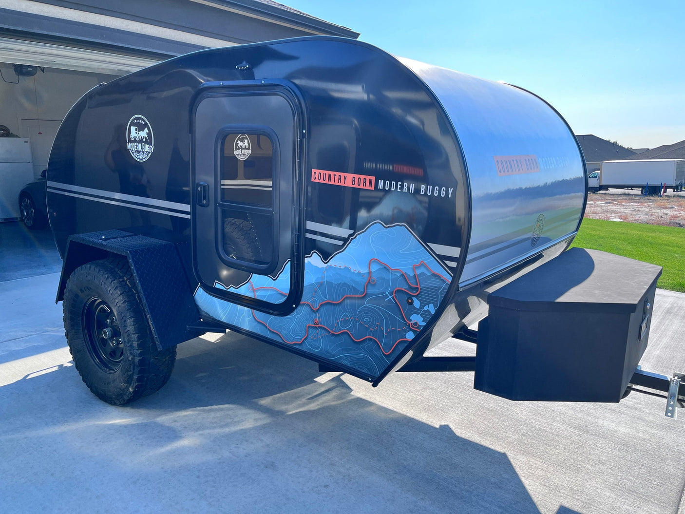  ideal for RV rental.|Black Modern Buggy off-road teardrop RV rental showing open sleeping area & galley kitchen.|Power up your RV rental adventures! This Jackery portable power station provides off-grid charging