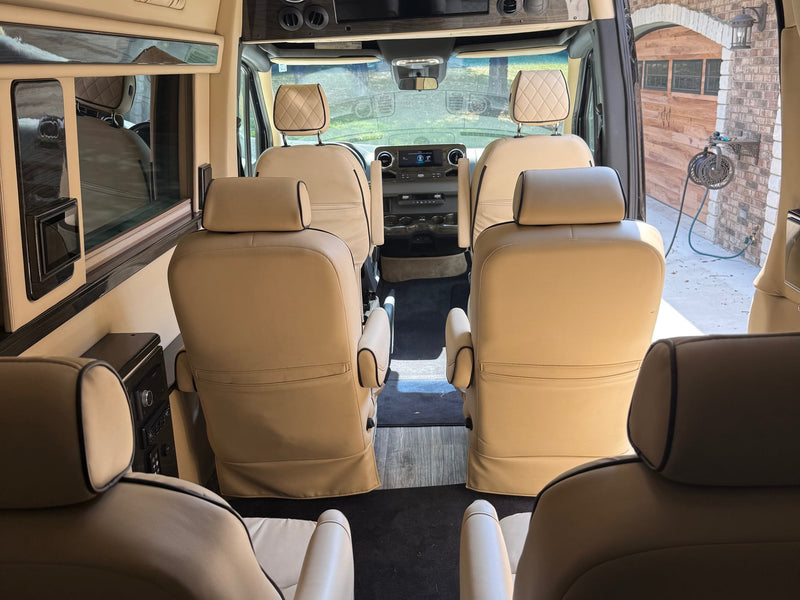  showcasing its modern design.|Plush cream captain's chairs with diamond stitching in a luxurious RV rental interior — photo 4