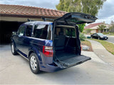 ready for adventure like an RV rental. Rear seats and cargo area visible.|Rear view of a vehicle with open tailgate & stowed seats