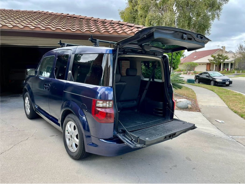  ready for adventure like an RV rental. Rear seats and cargo area visible.|Rear view of a vehicle with open tailgate & stowed seats — photo 8