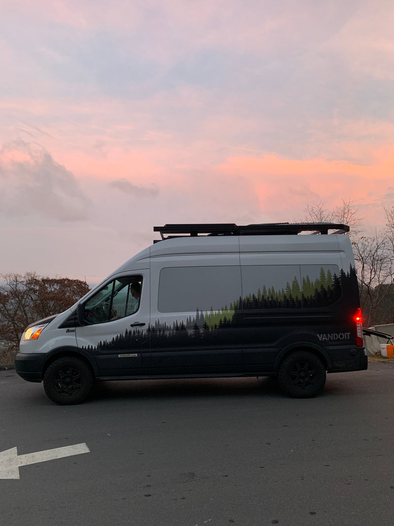 Experience van life! This sleek Vandoit camper van, available for RV rental, sports a forest design under a sunset sky. — photo 2