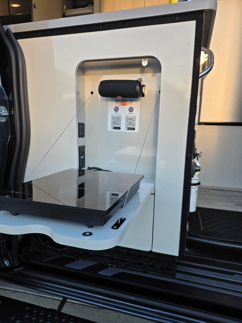 RV rental's smart outdoor kitchen: induction cooktop, power outlets, and Bluetooth speaker for convenient mobile cooking. — photo 15