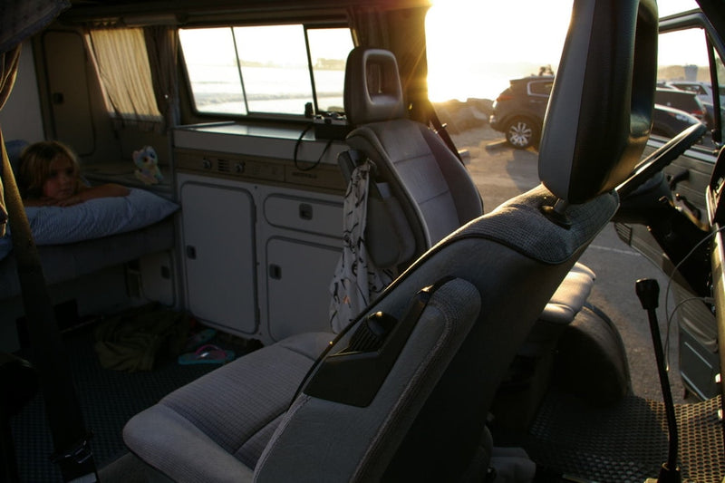  and two tables for dining.|Inside a cozy camper van at sunset — photo 3