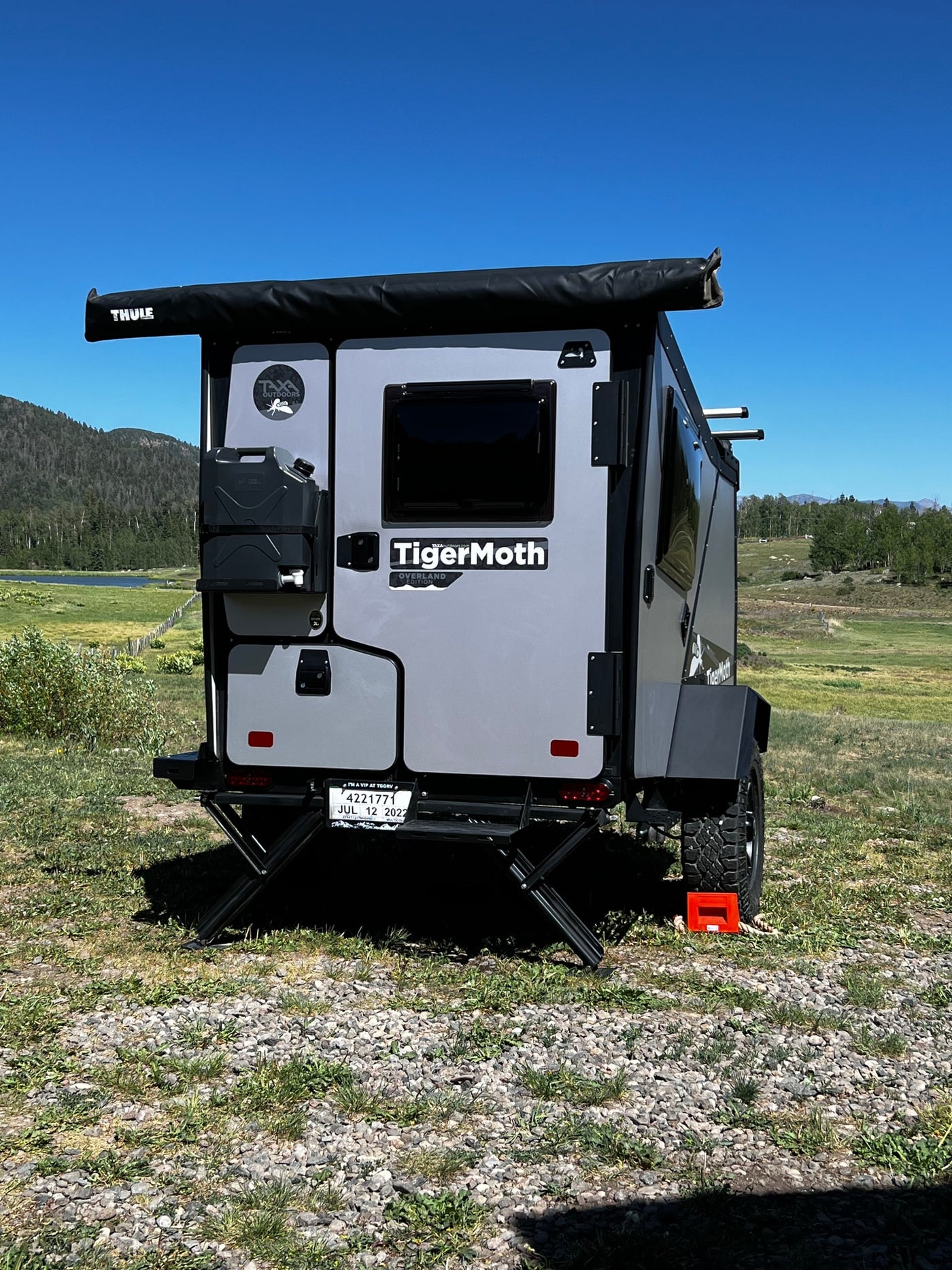 TigerMoth overland RV rental trailer: grey Taxa Outdoors model with Thule awning, ready for off-grid adventures. — photo 5