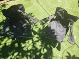 Portable comfort: Two black folding chairs with cup holders on green turf, ideal for an RV rental adventure.