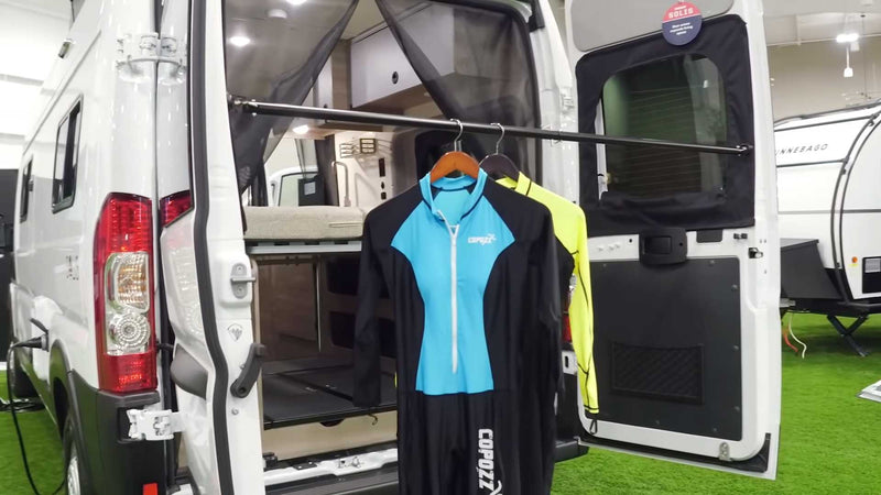  and underfloor storage in a modern camper van.|Spacious RV rental interior with a ladder leading to a cozy pop-top bed — photo 7