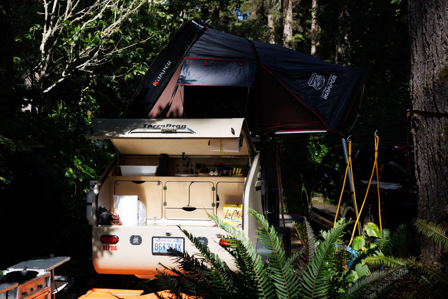  perfect for camping in nature.|RV rental's open tailgate reveals a compact outdoor kitchen with stove