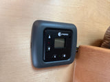 A black Propex climate control panel with display and buttons, mounted on light wood in an RV rental.