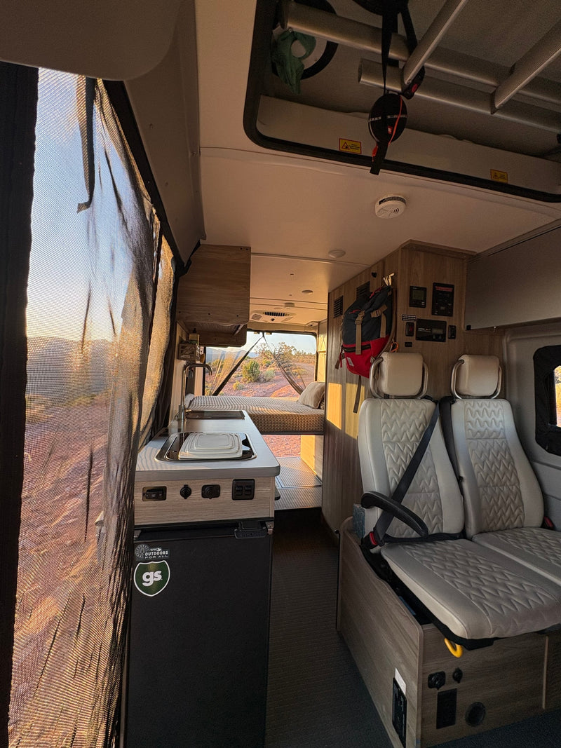  and amenities for your road trip comfort.|RV rental's inviting interior: features a comfy bed — photo 22