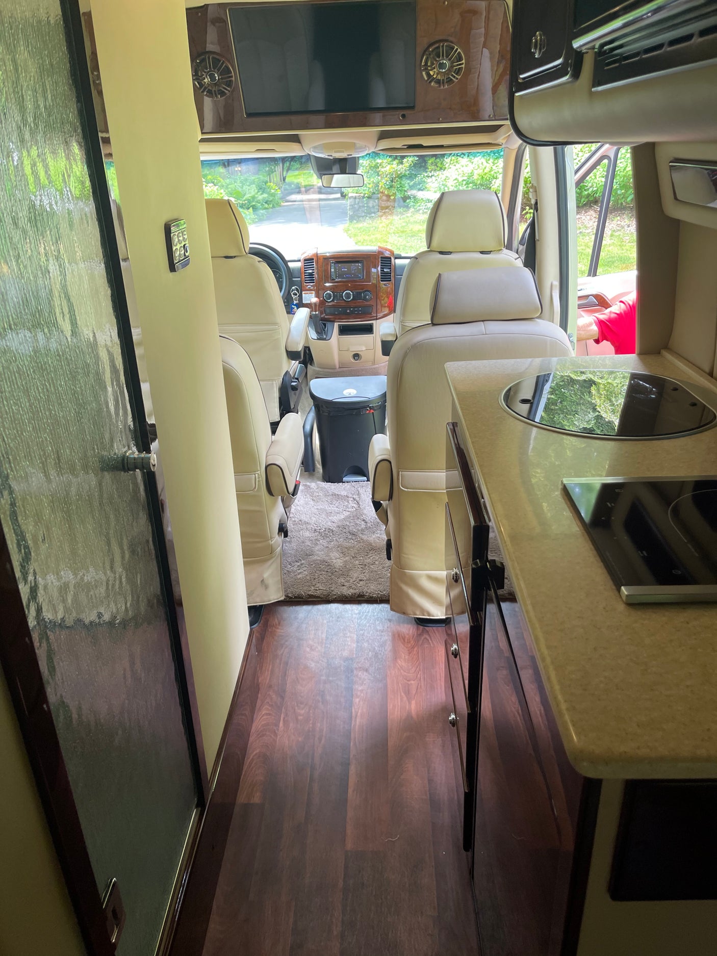 Spacious RV rental interior. View from rear showing kitchen, front cockpit, and seating. Perfect for your next adventure.