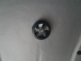 Essential for your rv rental: a ceiling-mounted ventilation fan. Features a black vent cover on a light gray fabric headliner.