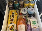 This well-stocked fridge inside an RV rental is packed with drinks, eggs, yogurt, and snacks, ready for a road trip adventure.