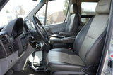 Spacious RV rental interior from the driver's perspective, showing two-tone leather seats, steering wheel, and dashboard.