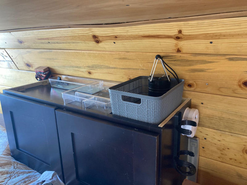  with a carpeted floor. Ideal camper kitchen setup.|Organized RV rental drawer: red mug — photo 16