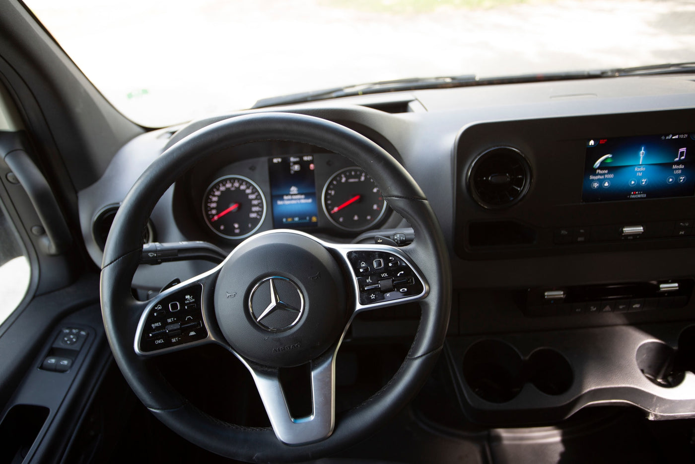 Modern RV rental interior: spacious driver's cabin with dashboard, steering wheel, and infotainment screen. — photo 11