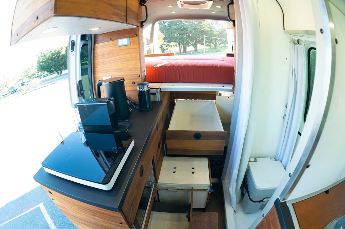  and bed setup for comfortable travel.|Inside an RV rental camper van — photo 7
