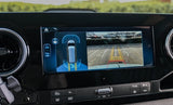 This RV rental's dashboard shows a rear camera view of a parking lot and active parking assist sensors on the infotainment screen.