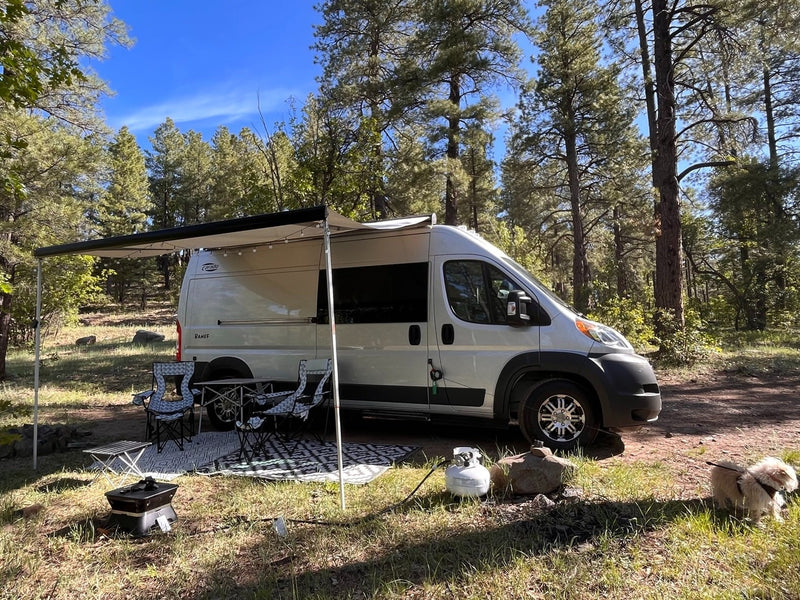 This RV rental camper van is set up for a campsite adventure with an awning — photo 1