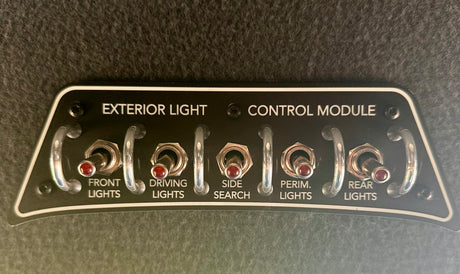 An rv rental exterior light control module, with five toggle switches for FRONT, DRIVING, SIDE SEARCH, PERIM., and REAR LIGHTS.