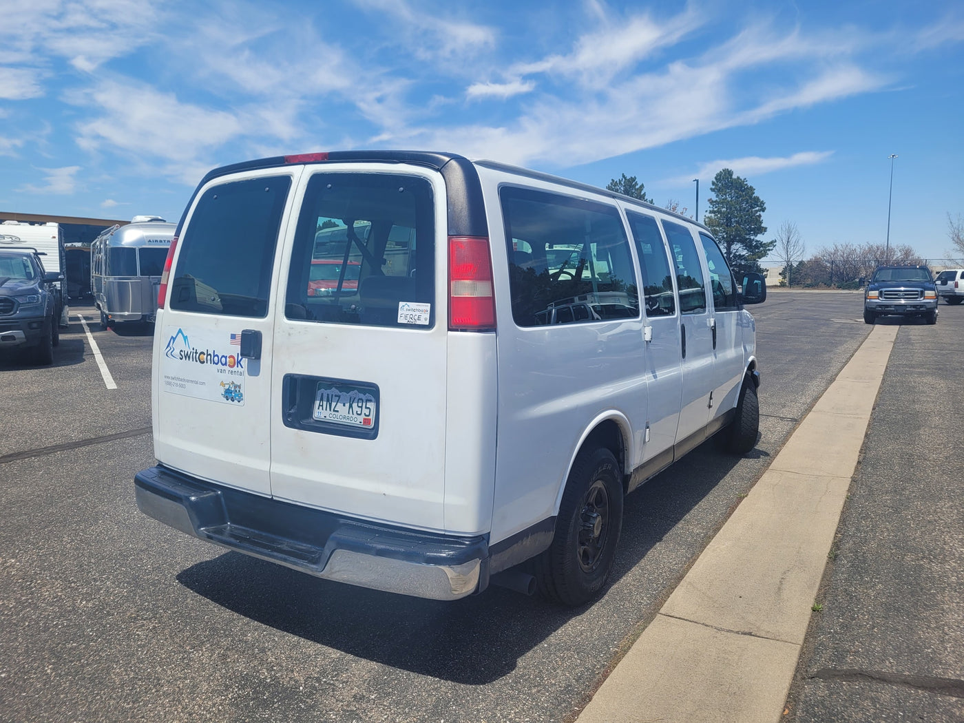  suggesting an RV rental lot.|A white passenger van — photo 3