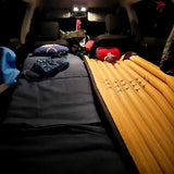 Comfy SUV car camping bed with sleeping mats & gear. A great alternative to an RV rental for your adventure trip.