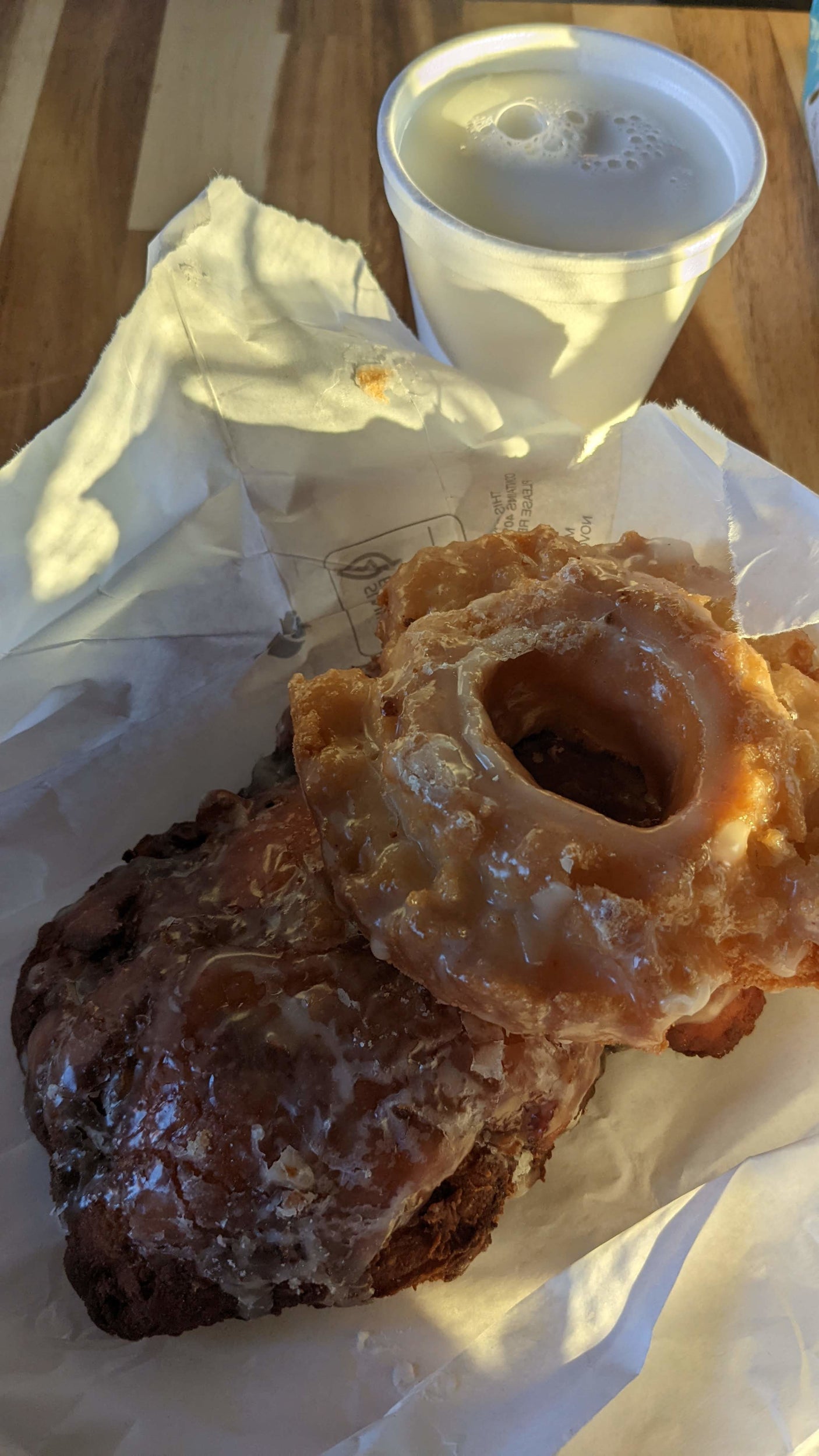 Glazed & chocolate donuts with milk, a delicious RV rental snack or breakfast, perfect for road trip travel.