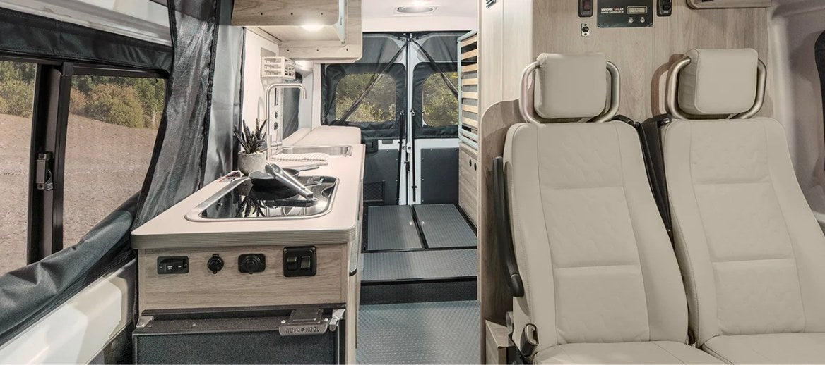  and scenic outdoor views from camper van.|Experience comfort in this RV rental! A pop-top camper bed with a patterned blanket — photo 2