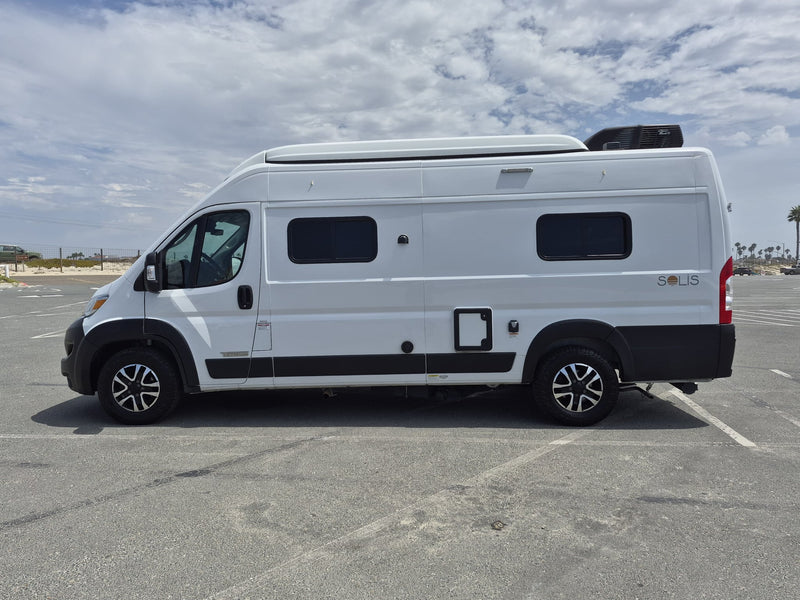  cloudy sky. Ready for travel!|White rv rental camper van parked by the beach under a partly cloudy sky — photo 5